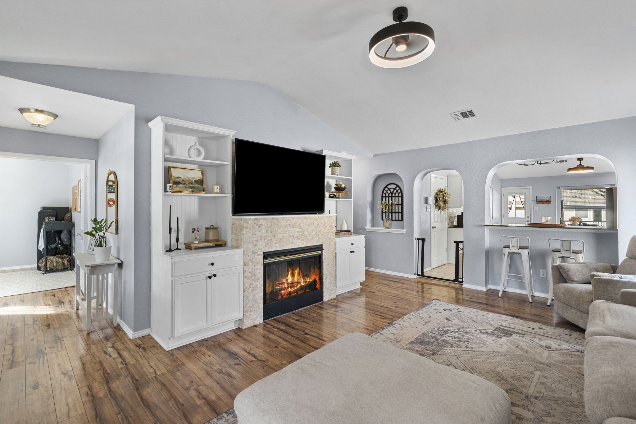 175 Wetzel Kyle, TX 78640 - Photo 3 of 40 Living area with light wood-type flooring, built in features, a tiled fireplace.