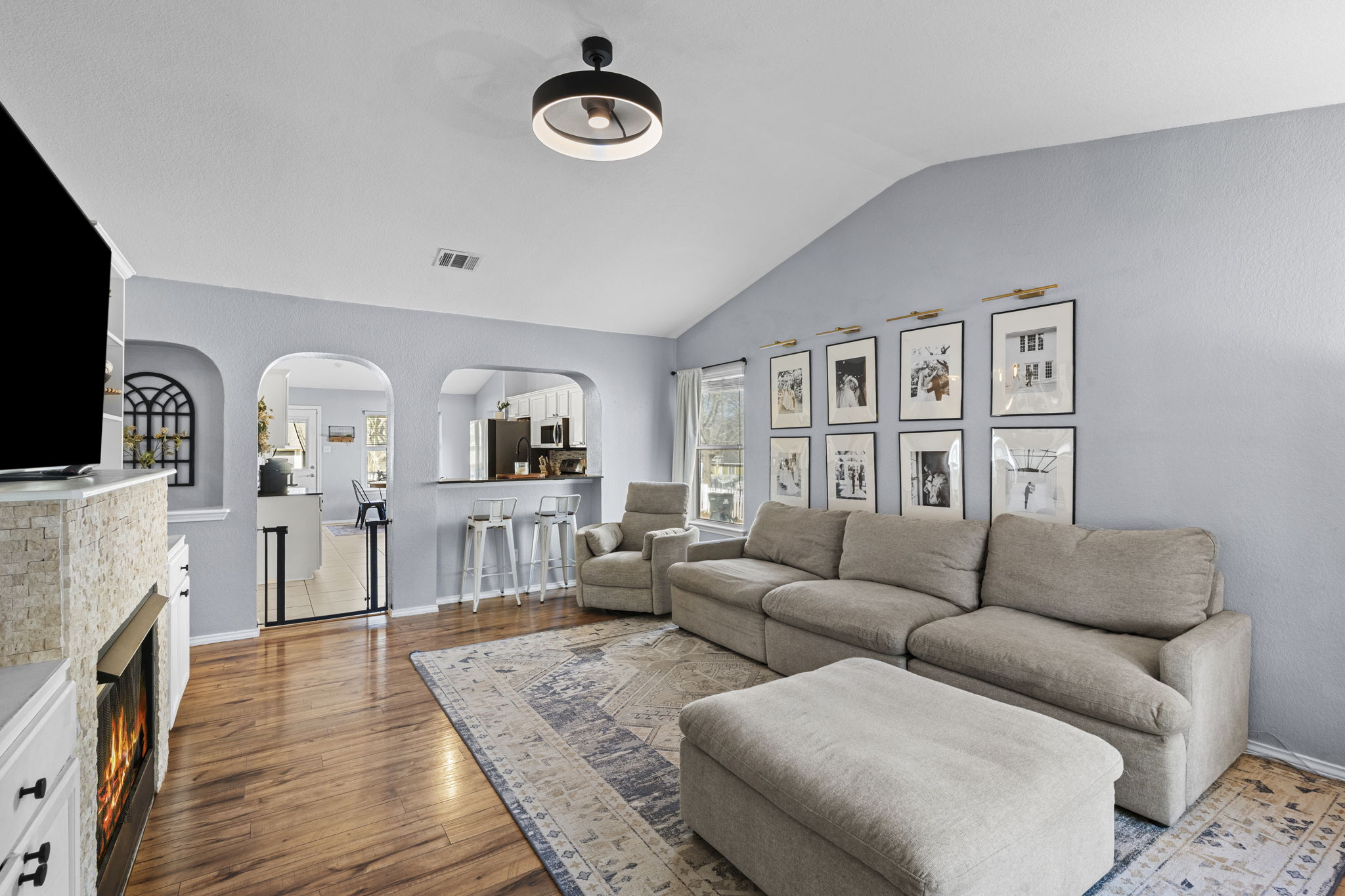 175 Wetzel Kyle, TX 78640 - Photo 4 of 40 Living room with vaulted ceilings open to kitchen