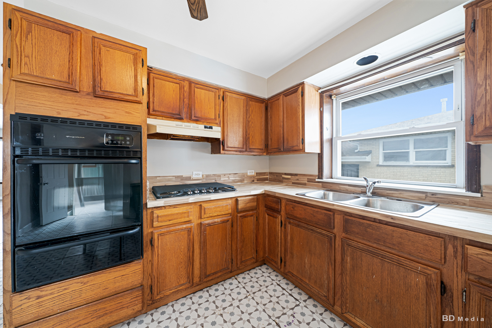 2223 West 156th Place Markham, IL 60426 - Photo 5 of 19 a kitchen with a sink stove and cabinets