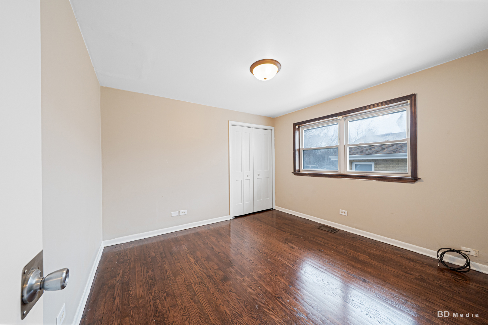 2223 West 156th Place Markham, IL 60426 - Photo 9 of 19 an empty room with wooden floor and windows