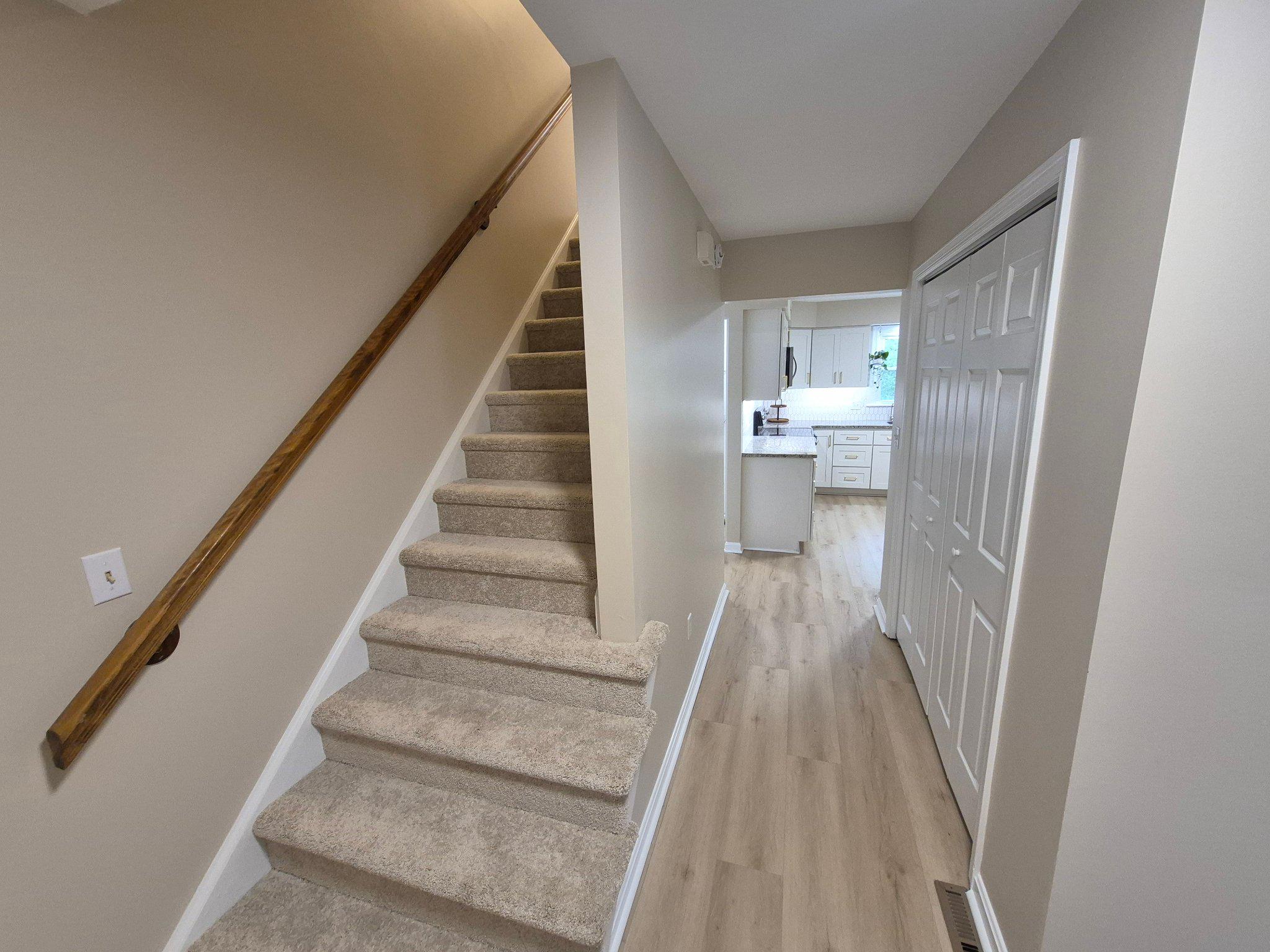 1406 Princeton Road Mechanicsburg, PA 17050 - Photo 15 of 53 a view of a hallway with wooden floor and staircase