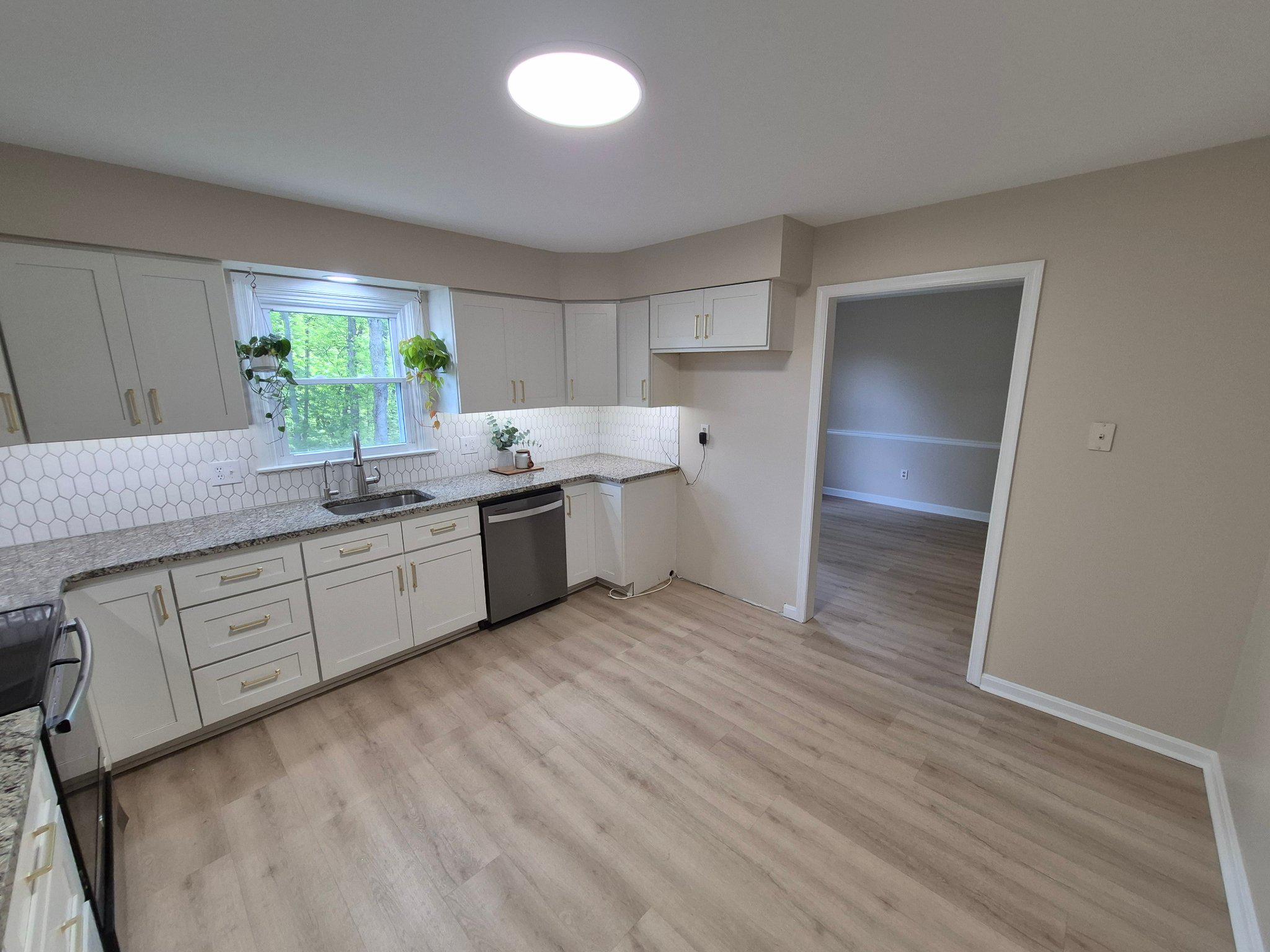 1406 Princeton Road Mechanicsburg, PA 17050 - Photo 17 of 53 a kitchen with stainless steel appliances granite countertop a sink and cabinets with wooden floor