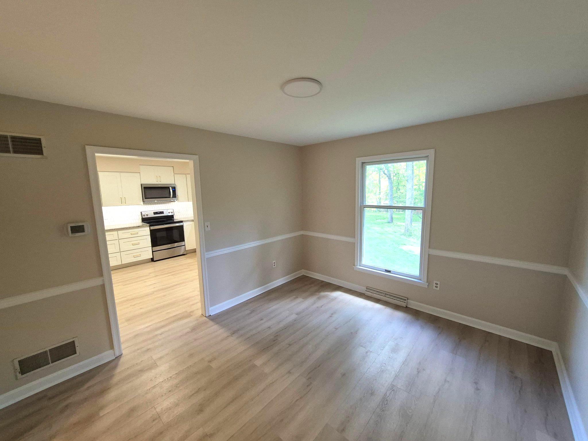 1406 Princeton Road Mechanicsburg, PA 17050 - Photo 22 of 53 wooden floor in an empty room with a window