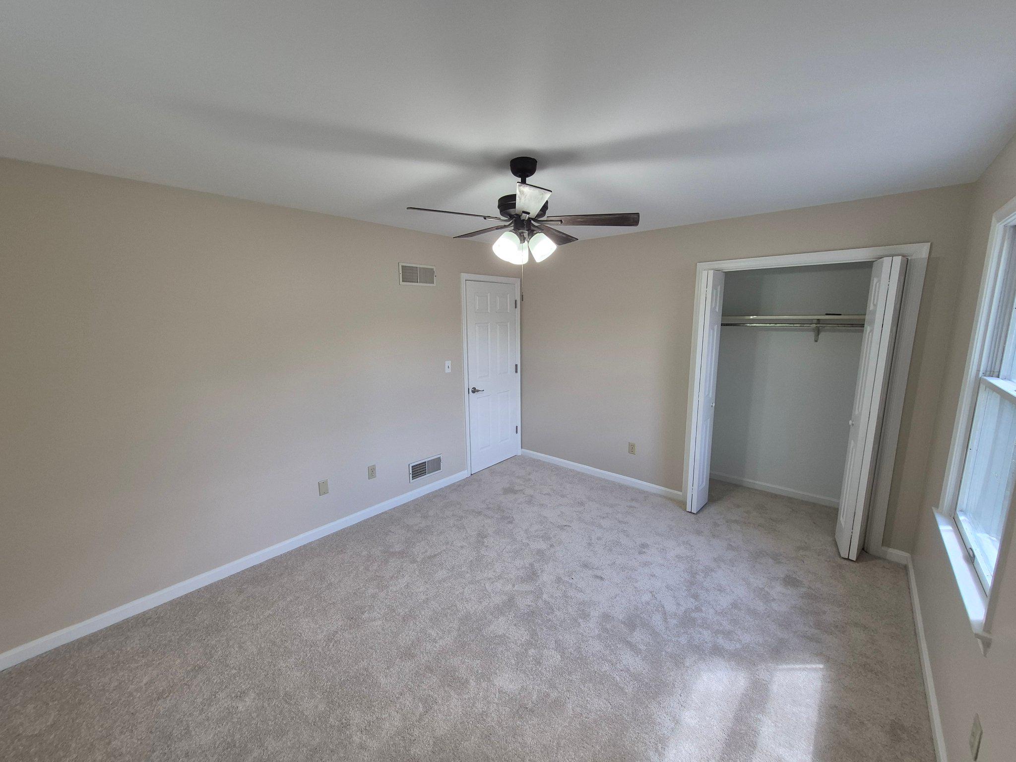 1406 Princeton Road Mechanicsburg, PA 17050 - Photo 34 of 53 an empty room with a ceiling fan and a window