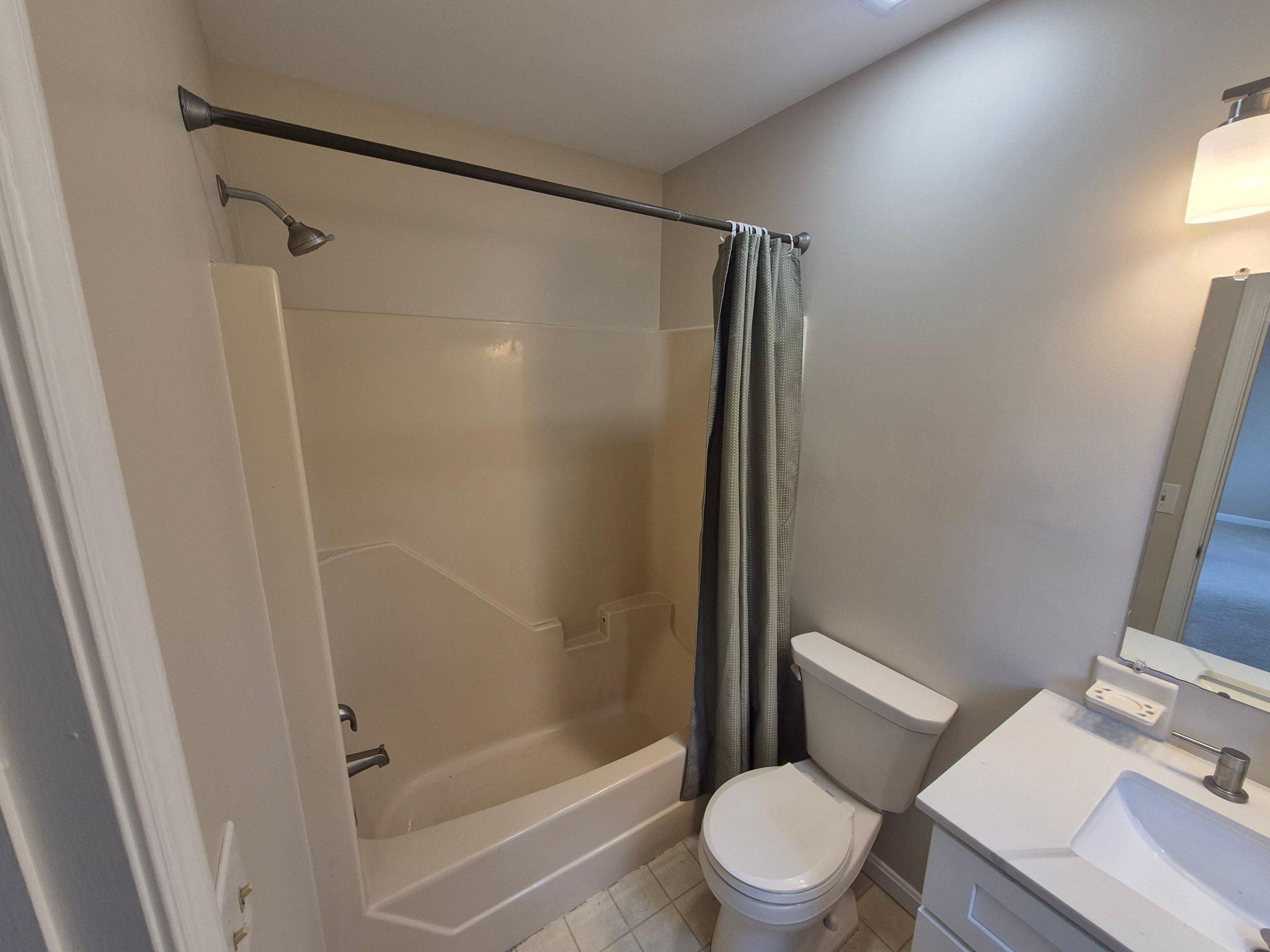 1406 Princeton Road Mechanicsburg, PA 17050 - Photo 38 of 53 a white toilet sitting next to a bathroom sink and a shower