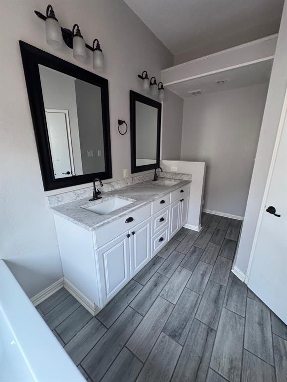 10025 Long Rifle Drive Fort Worth, TX 76108 - Photo 14 of 28 a bathroom with a double vanity sink and mirror