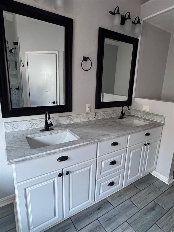 10025 Long Rifle Drive Fort Worth, TX 76108 - Photo 15 of 28 a bathroom with a granite countertop sink vanity and mirror