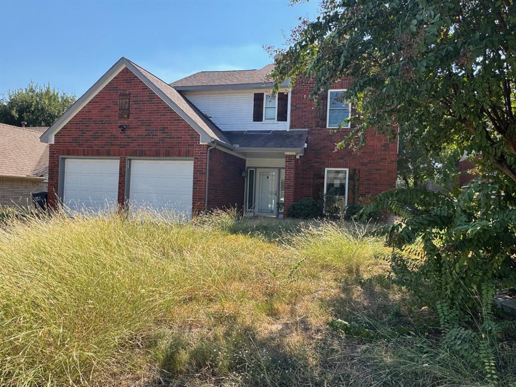10025 Long Rifle Drive Fort Worth, TX 76108 - Photo 2 of 28 a front view of a house with a yard and garage