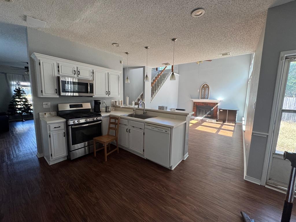 10025 Long Rifle Drive Fort Worth, TX 76108 - Photo 8 of 28 a kitchen with a sink cabinets and wooden floor