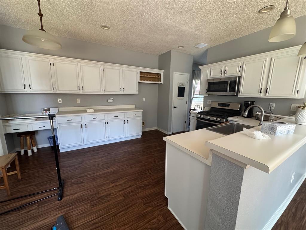 10025 Long Rifle Drive Fort Worth, TX 76108 - Photo 9 of 28 a kitchen with a sink a stove and cabinets