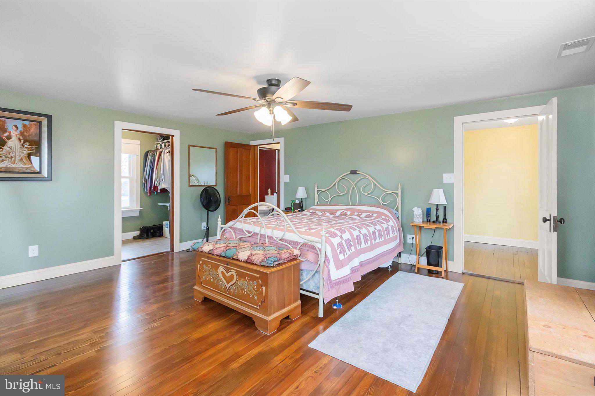 11853 White Hall Road Smithsburg, MD 21783 - Photo 16 of 40 a bedroom with a bed and a chandelier