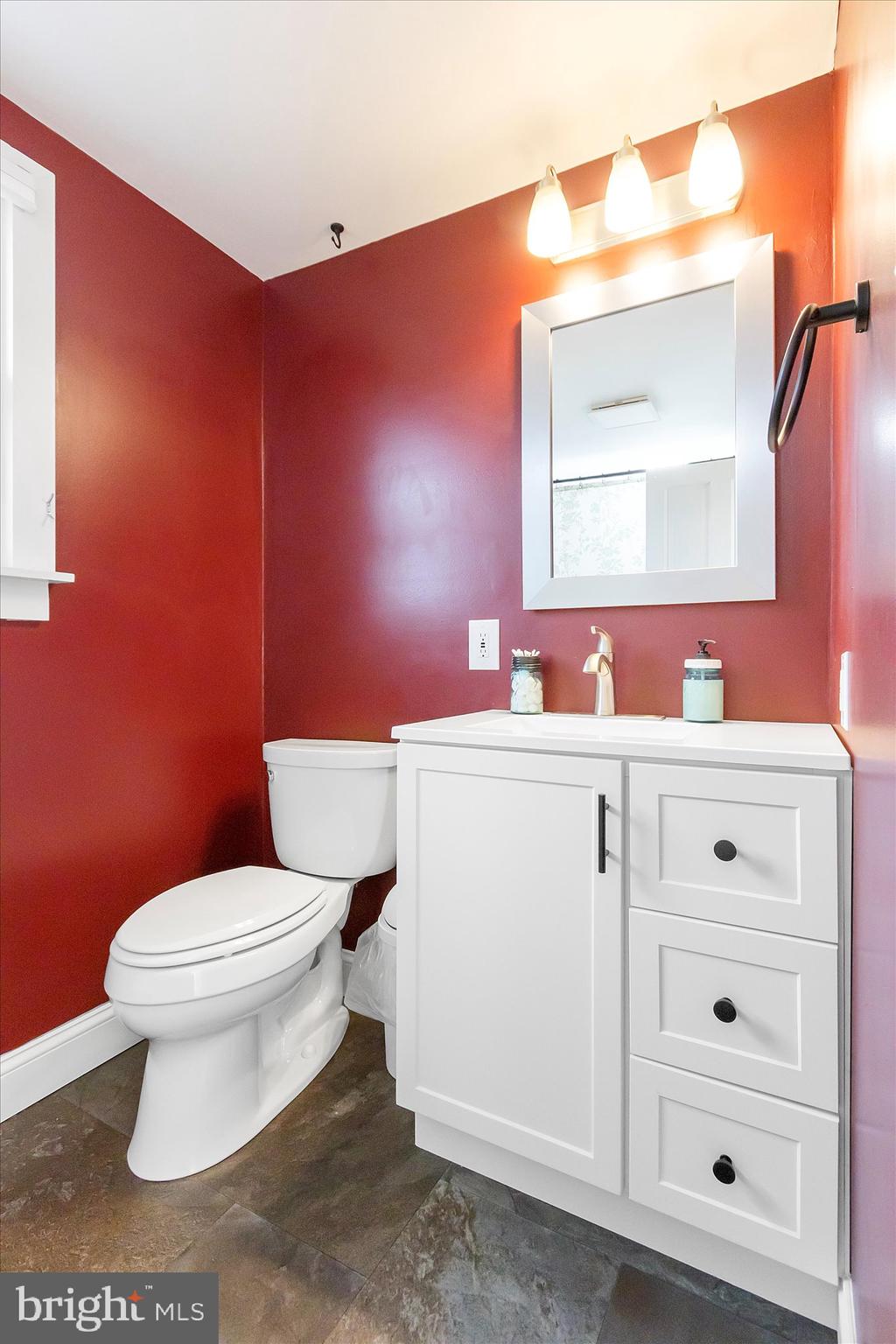 11853 White Hall Road Smithsburg, MD 21783 - Photo 20 of 40 a bathroom with a toilet a sink a mirror and vanity