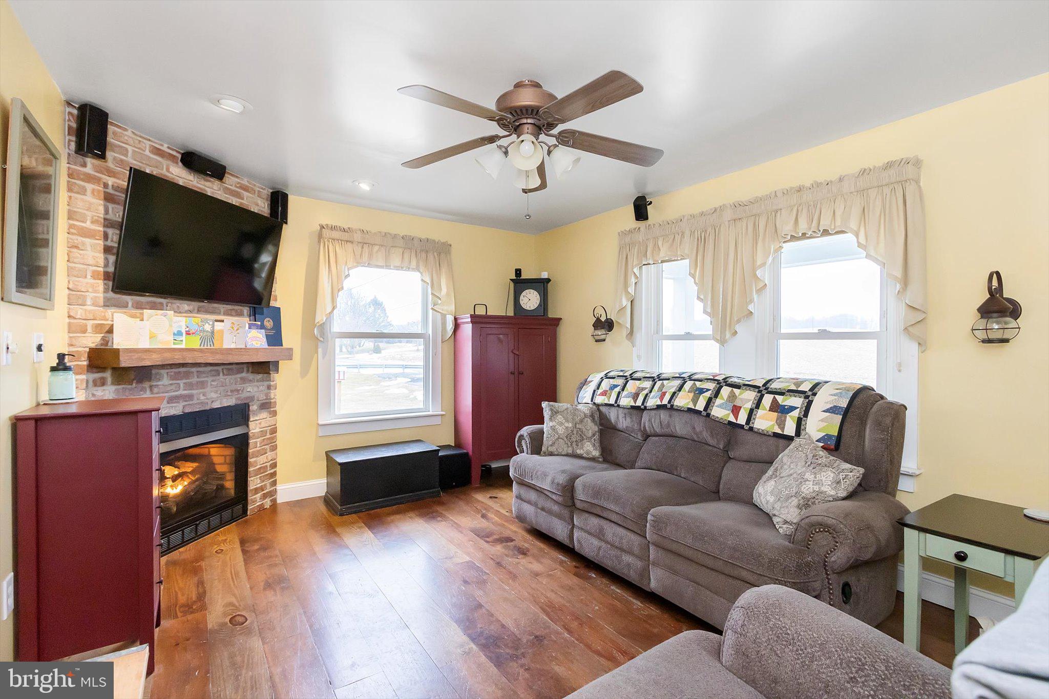 11853 White Hall Road Smithsburg, MD 21783 - Photo 4 of 40 a living room with fireplace furniture and a flat screen tv