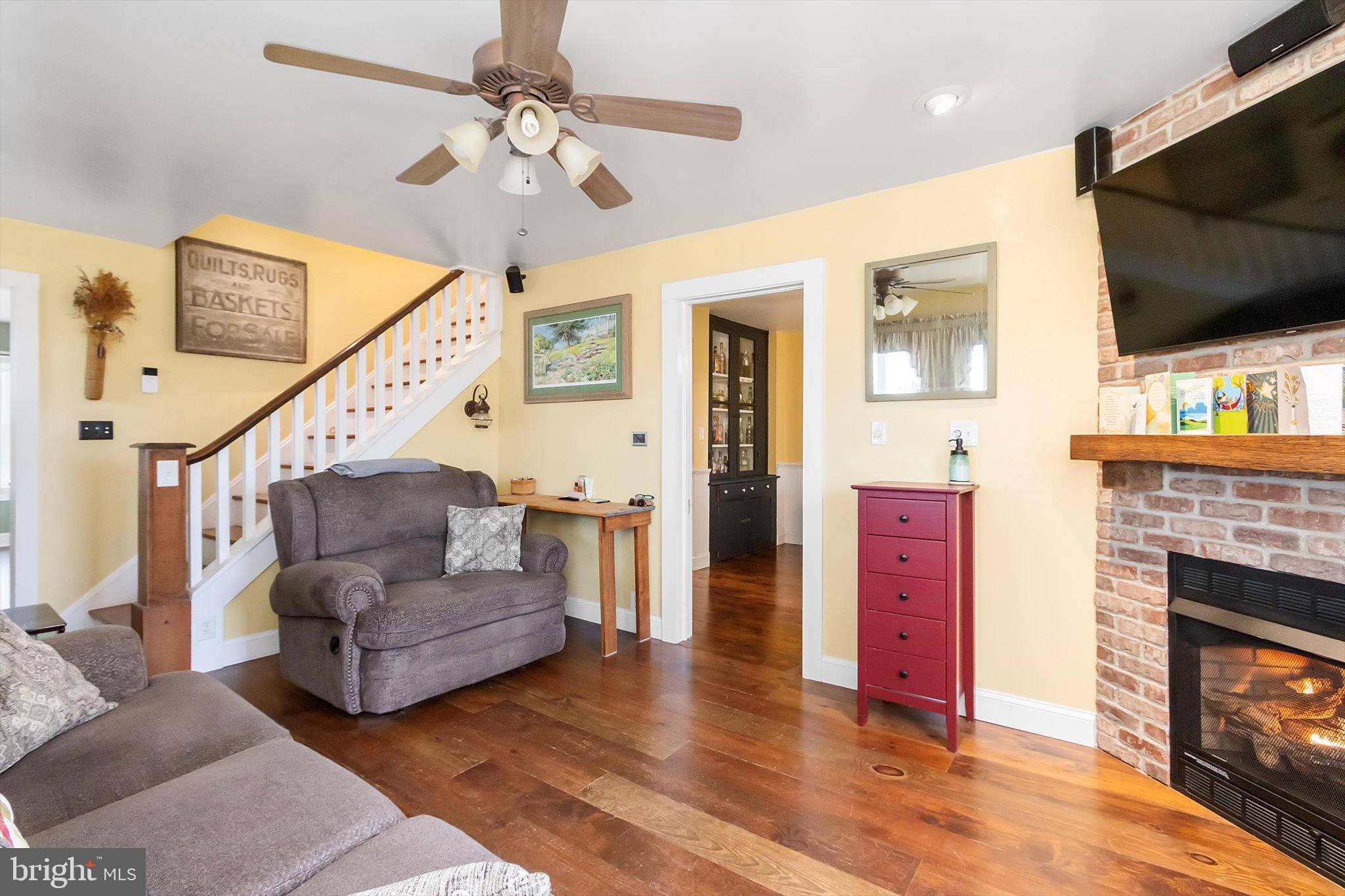 11853 White Hall Road Smithsburg, MD 21783 - Photo 5 of 40 a living room with furniture a flat screen tv and a fireplace