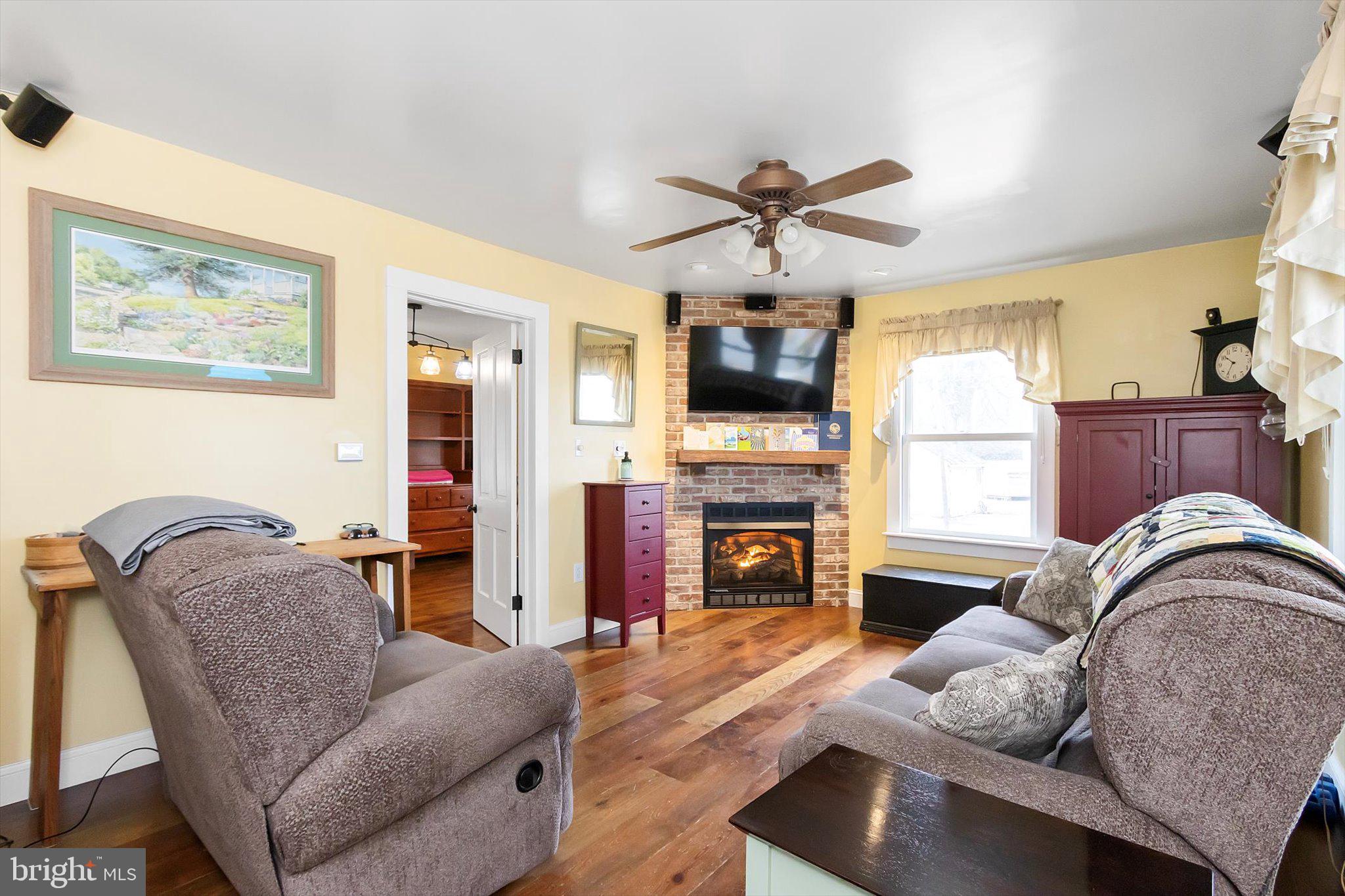 11853 White Hall Road Smithsburg, MD 21783 - Photo 6 of 40 a living room with furniture fireplace and flat screen tv