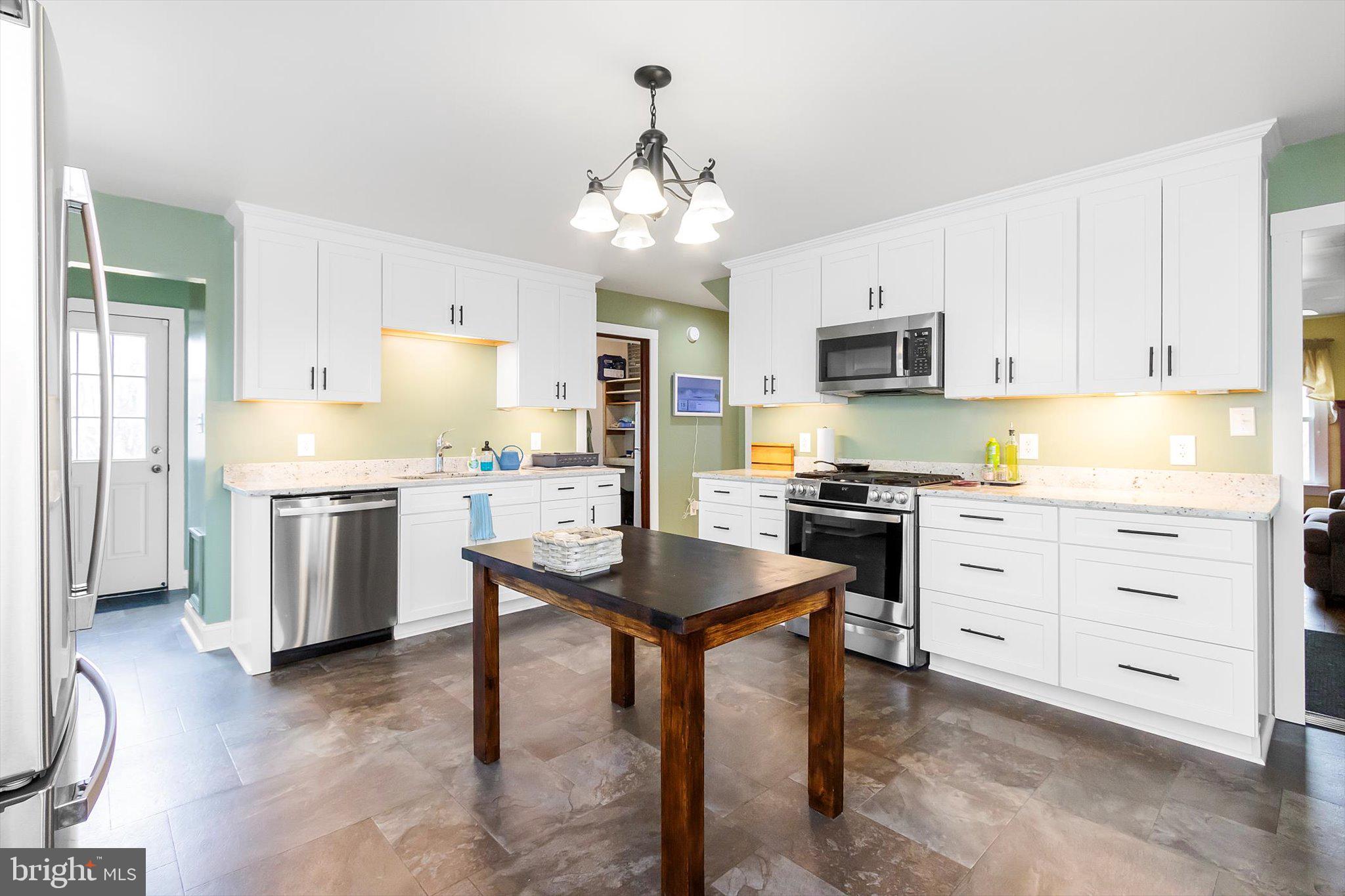 11853 White Hall Road Smithsburg, MD 21783 - Photo 7 of 40 a kitchen with granite countertop white cabinets and stainless steel appliances