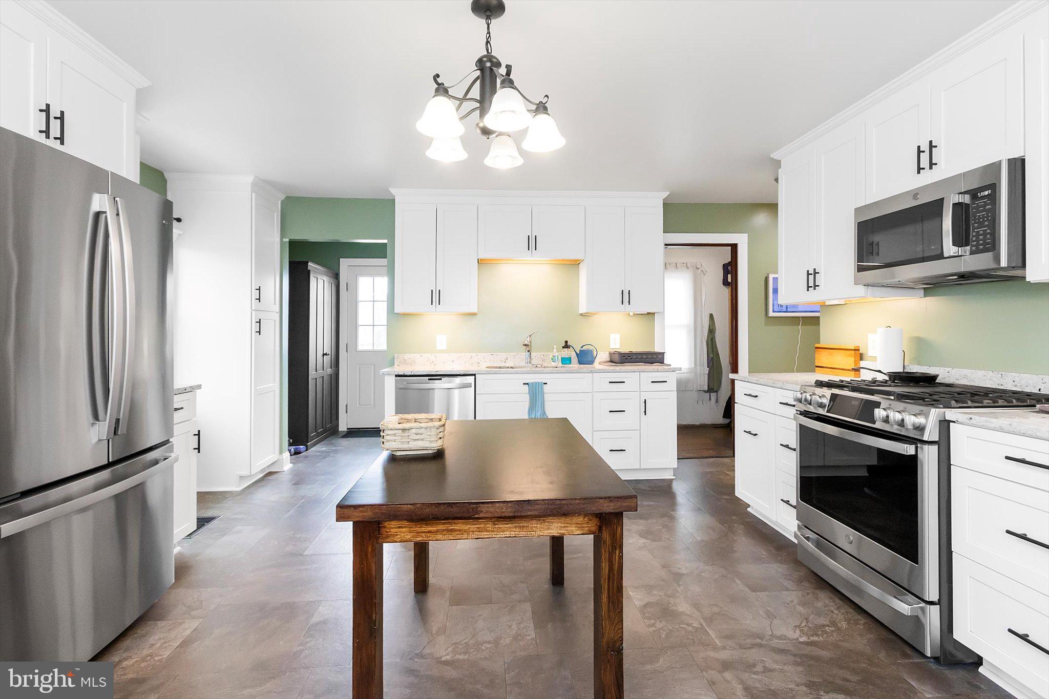 11853 White Hall Road Smithsburg, MD 21783 - Photo 8 of 40 a kitchen with stainless steel appliances granite countertop a stove a refrigerator and a microwave