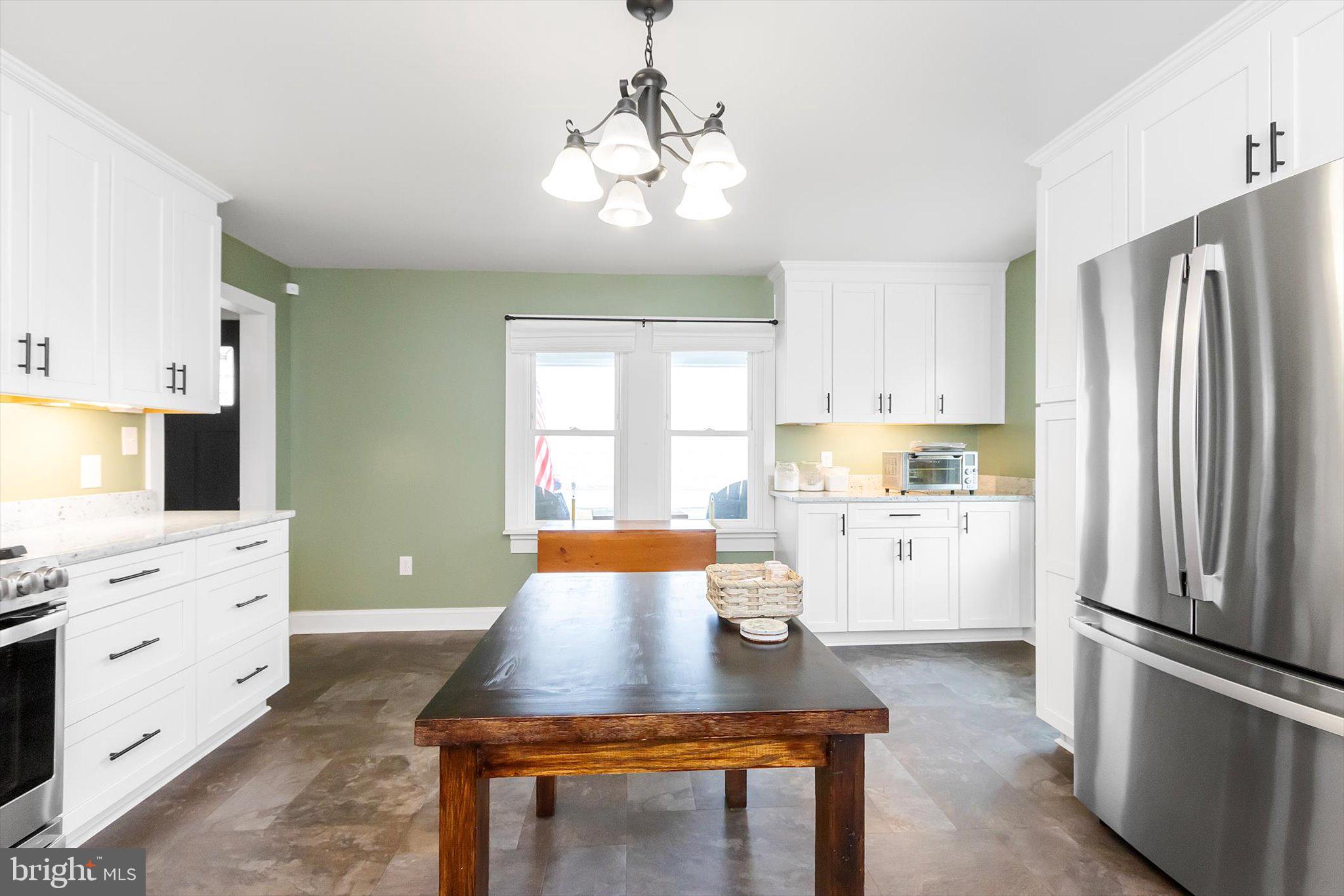 11853 White Hall Road Smithsburg, MD 21783 - Photo 9 of 40 a kitchen with white cabinets and stainless steel appliances