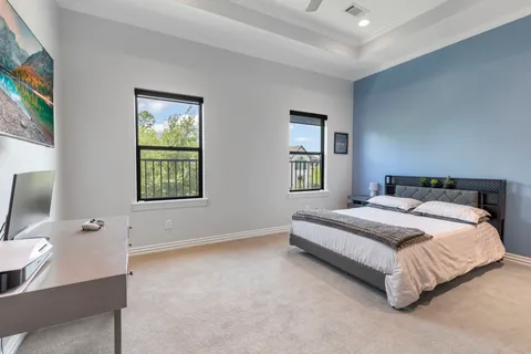 a spacious bedroom with a bed and a window