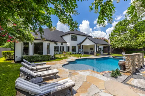a view of a house with swimming pool and porch with furniture