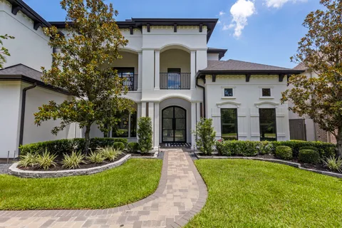 a front view of a house with swimming tub and entertaining space