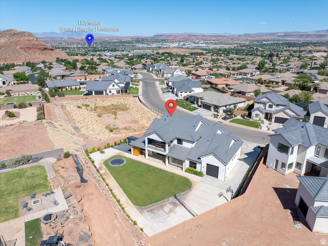 1192 East Corral Way Washington, UT 84780 - Photo 77 of 81 Contemporary two-story residence featuring a dark tile roof, white exterior, and integrated double garage