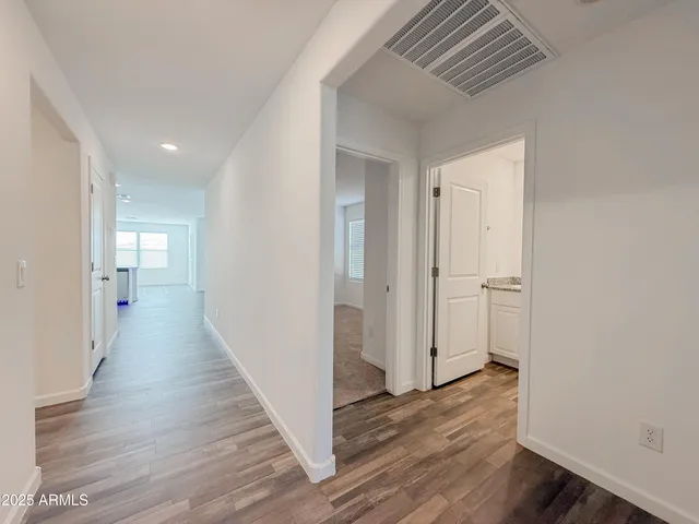 a view of a hallway with wooden floor