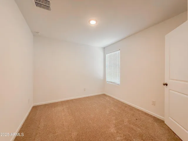 an empty room with a empty space and windows