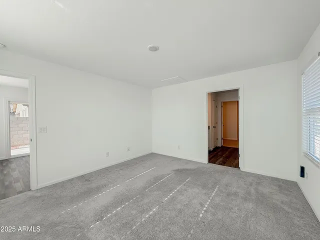 a view of an empty room and closet area