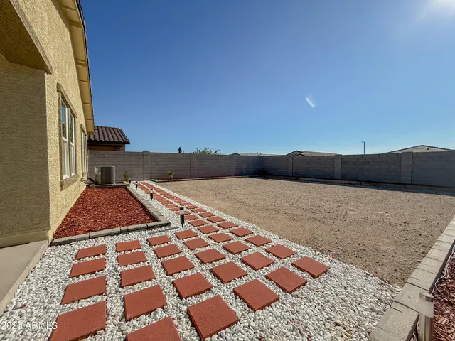 a bedroom with a bed and a black white checkered floor