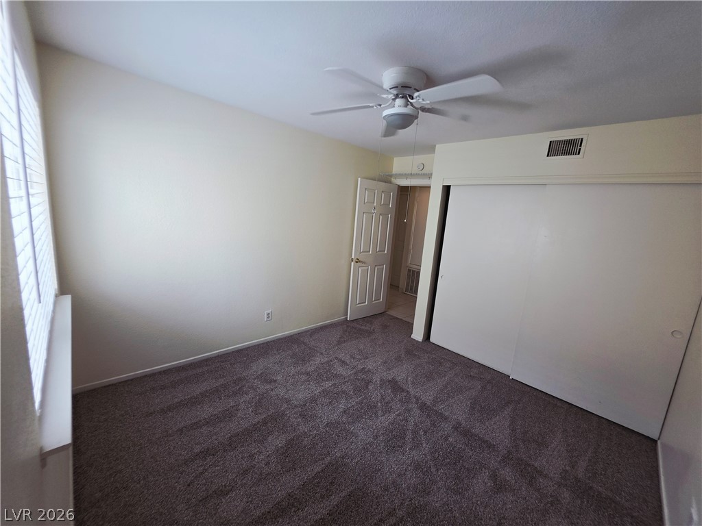 2920 Setting Sun Street Las Vegas, NV 89117 - Photo 30 of 43 This cozy bedroom features comfortable carpeting and a ceiling fan for optimal comfort.