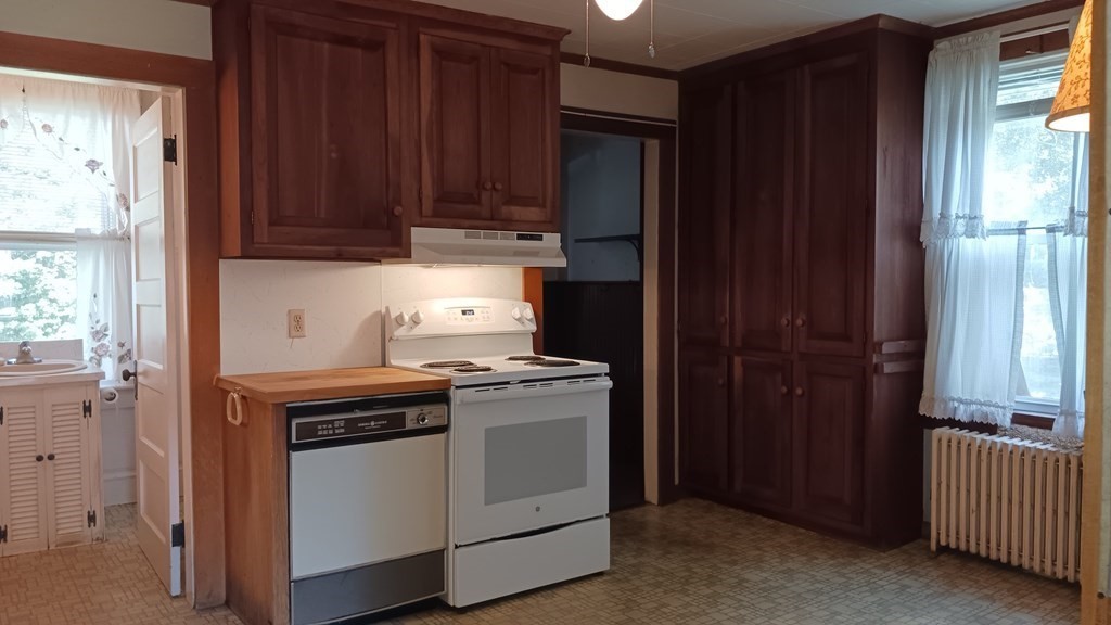 31 Orange Street Athol, MA 01331 - Photo 7 of 29 a kitchen with stainless steel appliances wooden cabinets and a stove top oven