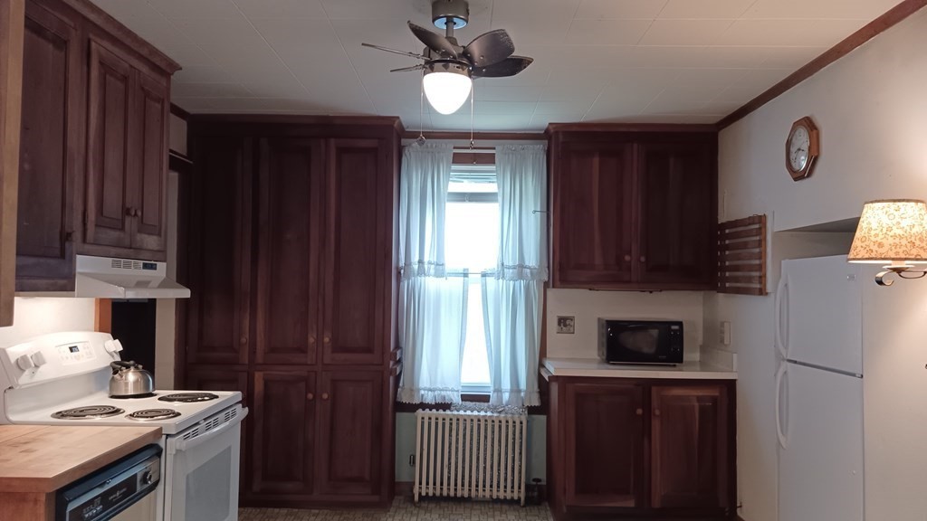 31 Orange Street Athol, MA 01331 - Photo 8 of 29 a kitchen with stainless steel appliances granite countertop a stove cabinets and a refrigerator