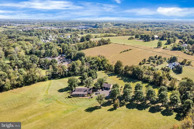 an aerial view of residential houses with outdoor space and lake view