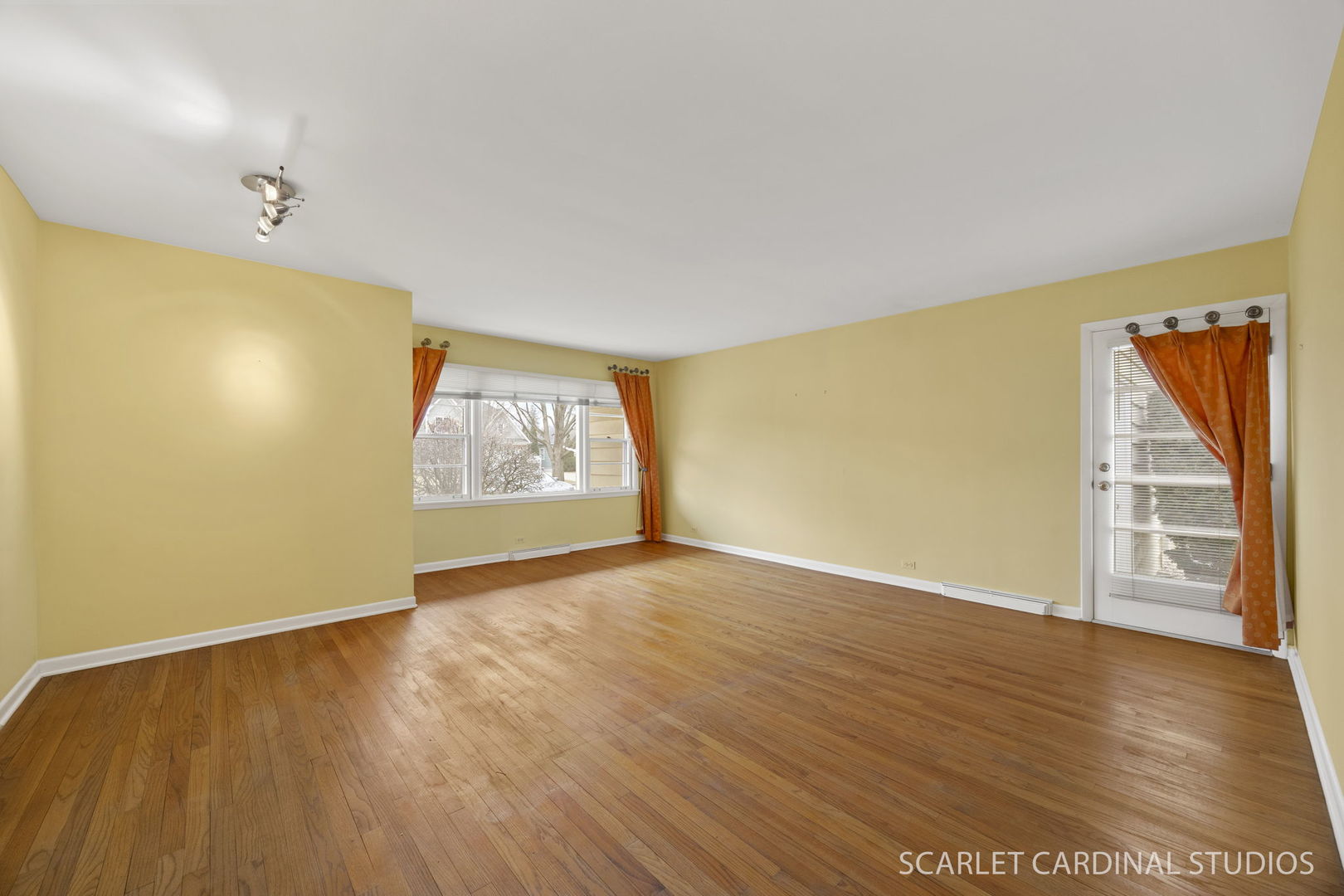 110 Travers Avenue Wheaton, IL 60187 - Photo 2 of 15 an empty room with wooden floor and windows