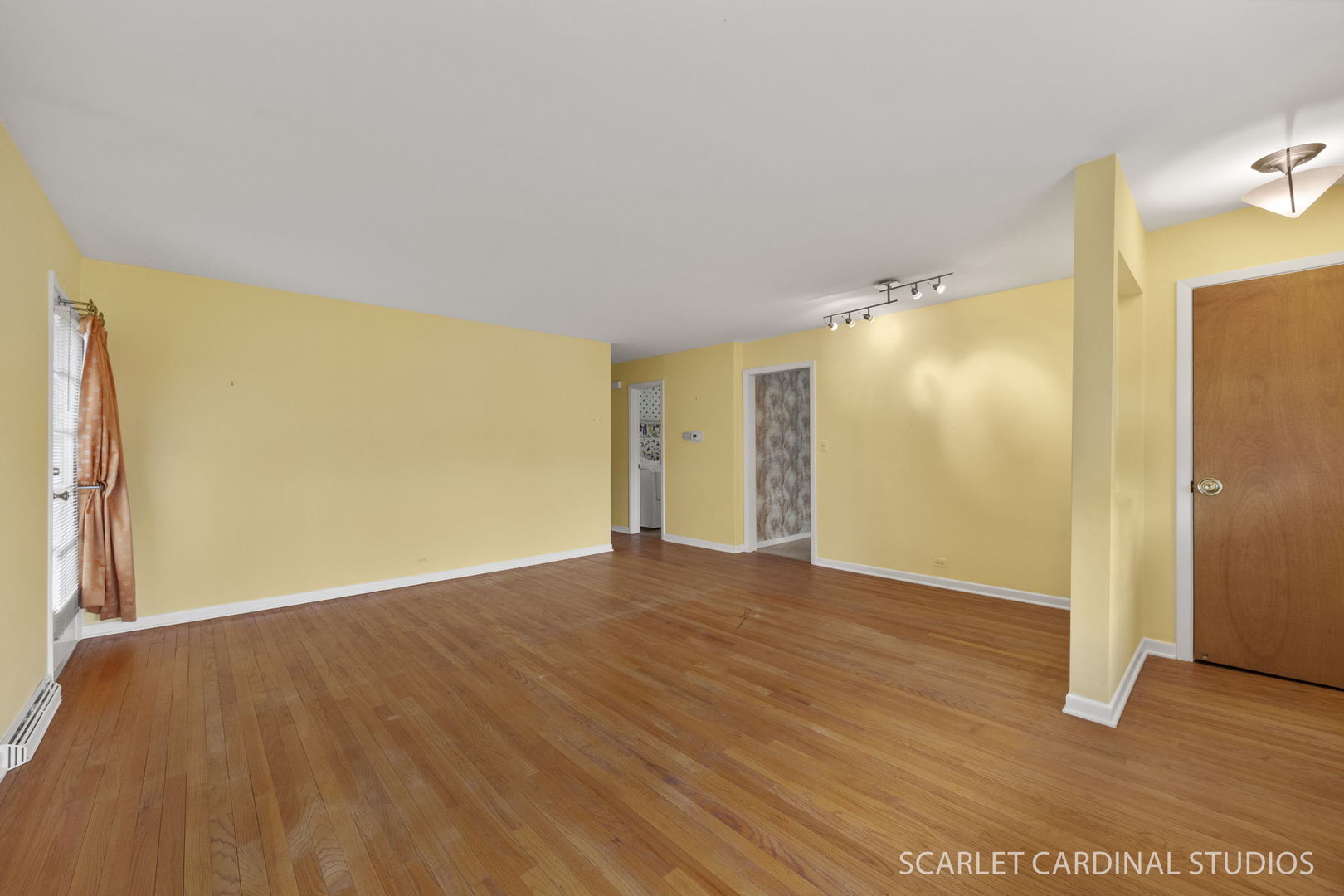 110 Travers Avenue Wheaton, IL 60187 - Photo 3 of 15 a view of an empty room with wooden floor and a window