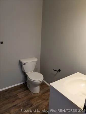 a white toilet sitting next to a white wall