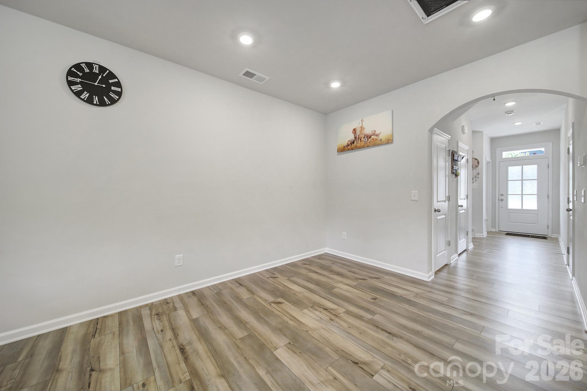 8042 Scarlet Maple Lane Fort Mill, SC 29708 - Photo 11 of 37 an empty room with wooden floor and windows