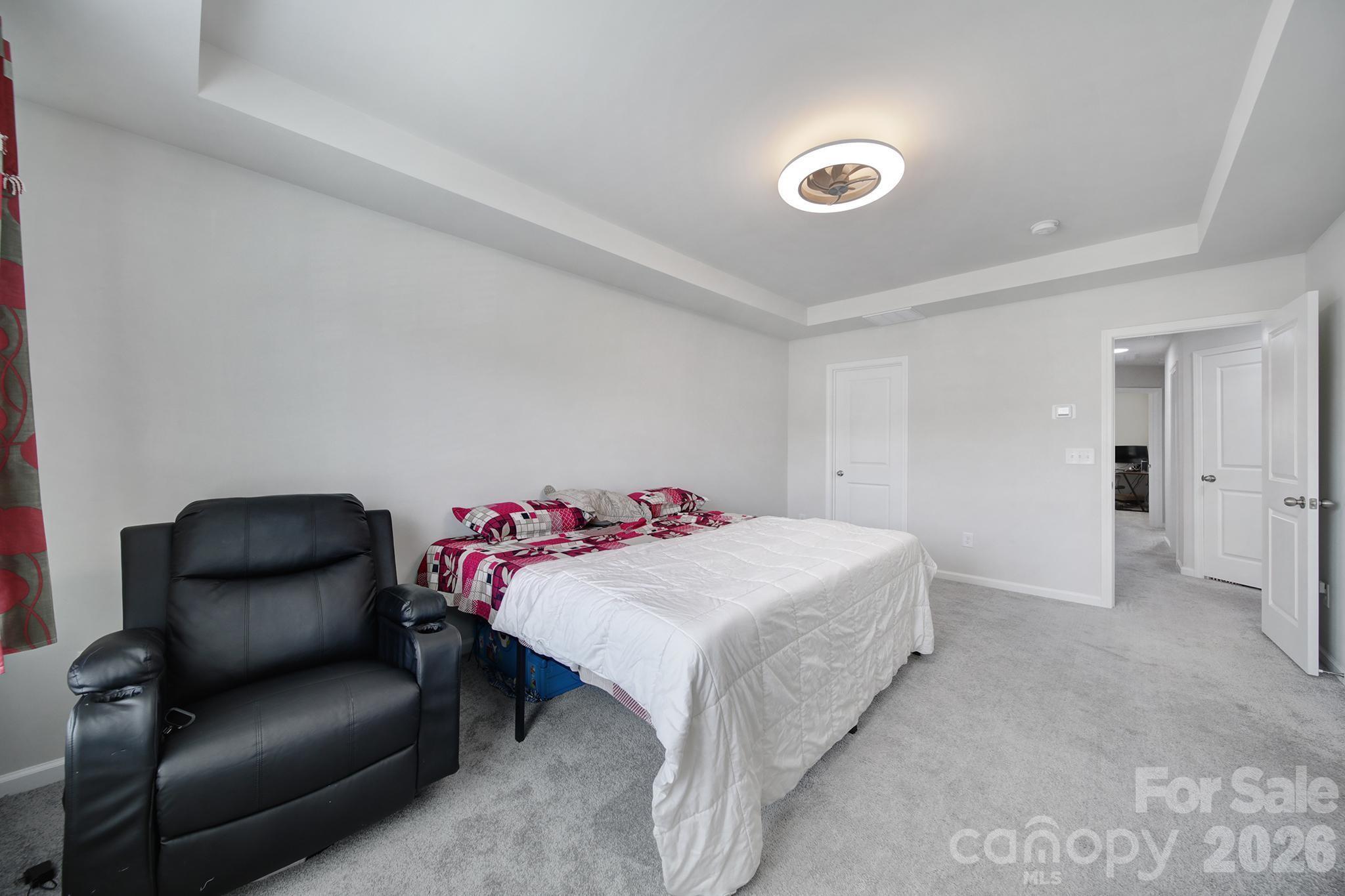 8042 Scarlet Maple Lane Fort Mill, SC 29708 - Photo 17 of 37 a bedroom with a bed and a chair