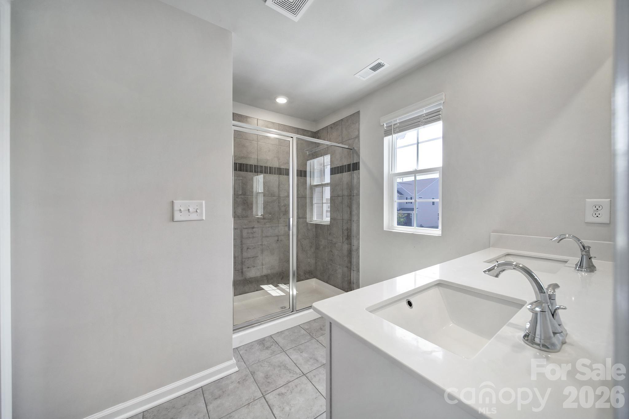 8042 Scarlet Maple Lane Fort Mill, SC 29708 - Photo 19 of 37 a bathroom with a sink a shower and bathtub