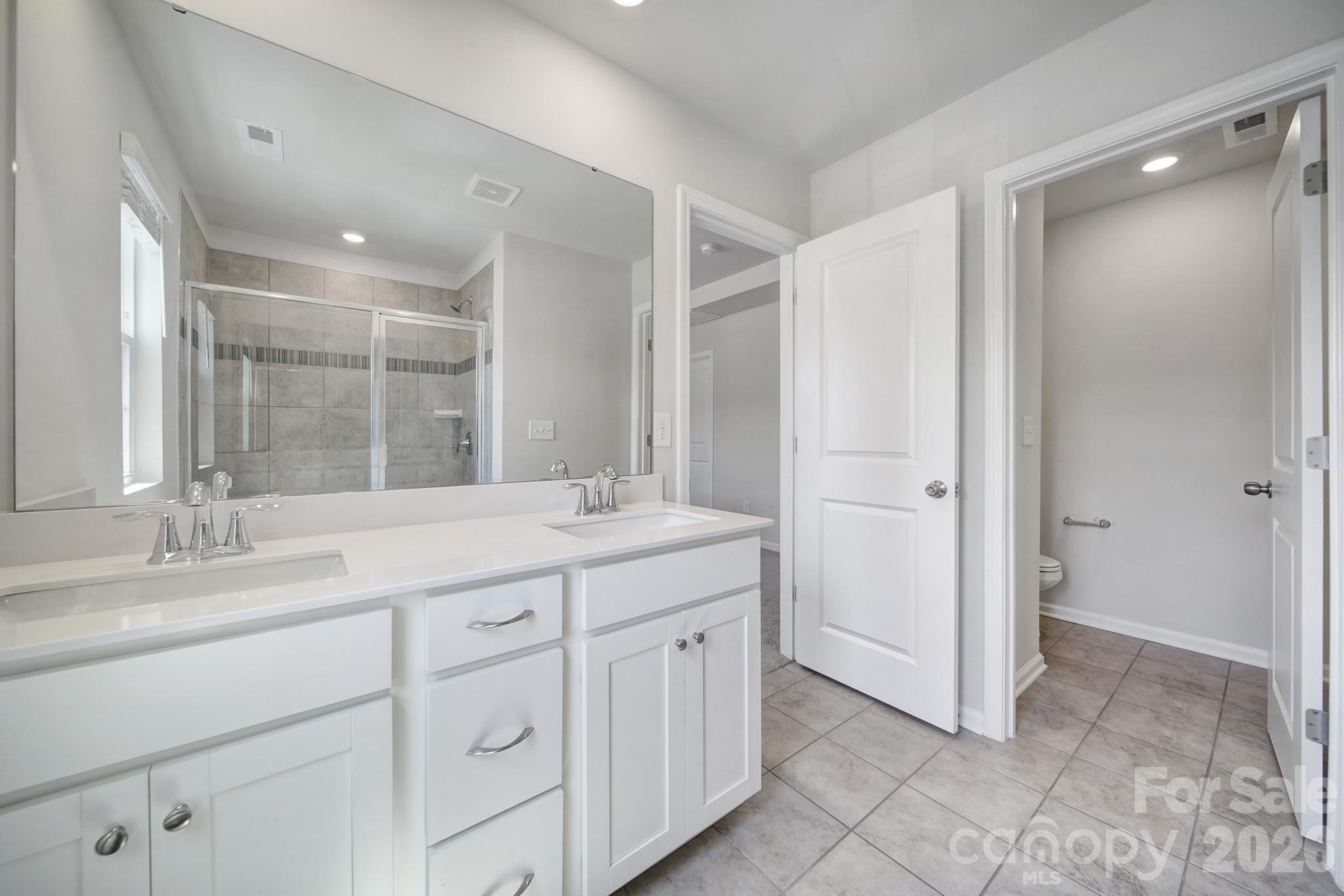 8042 Scarlet Maple Lane Fort Mill, SC 29708 - Photo 20 of 37 a bathroom with a granite countertop sink mirror and double