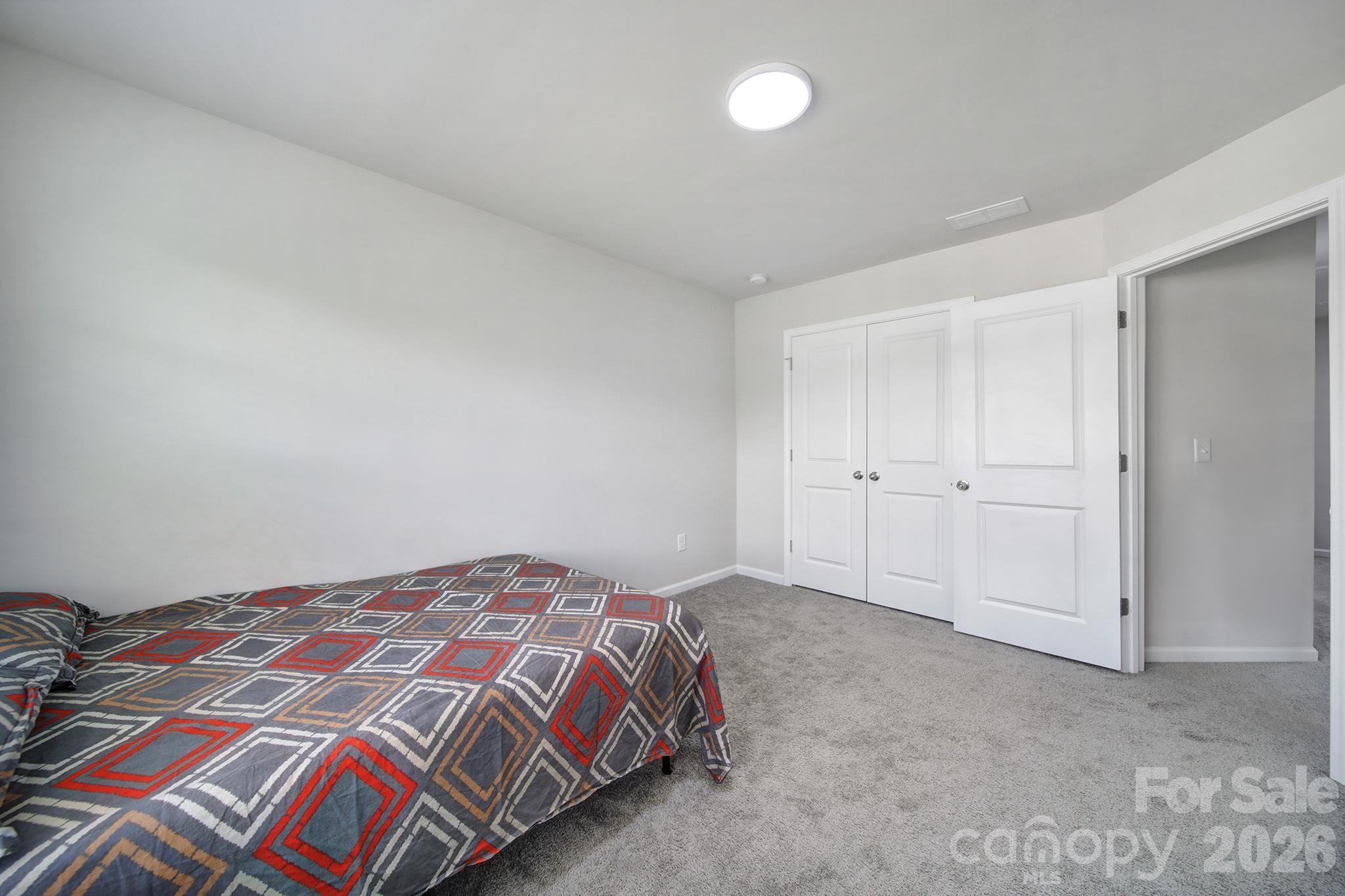 8042 Scarlet Maple Lane Fort Mill, SC 29708 - Photo 23 of 37 a bedroom with a bed and a lamp