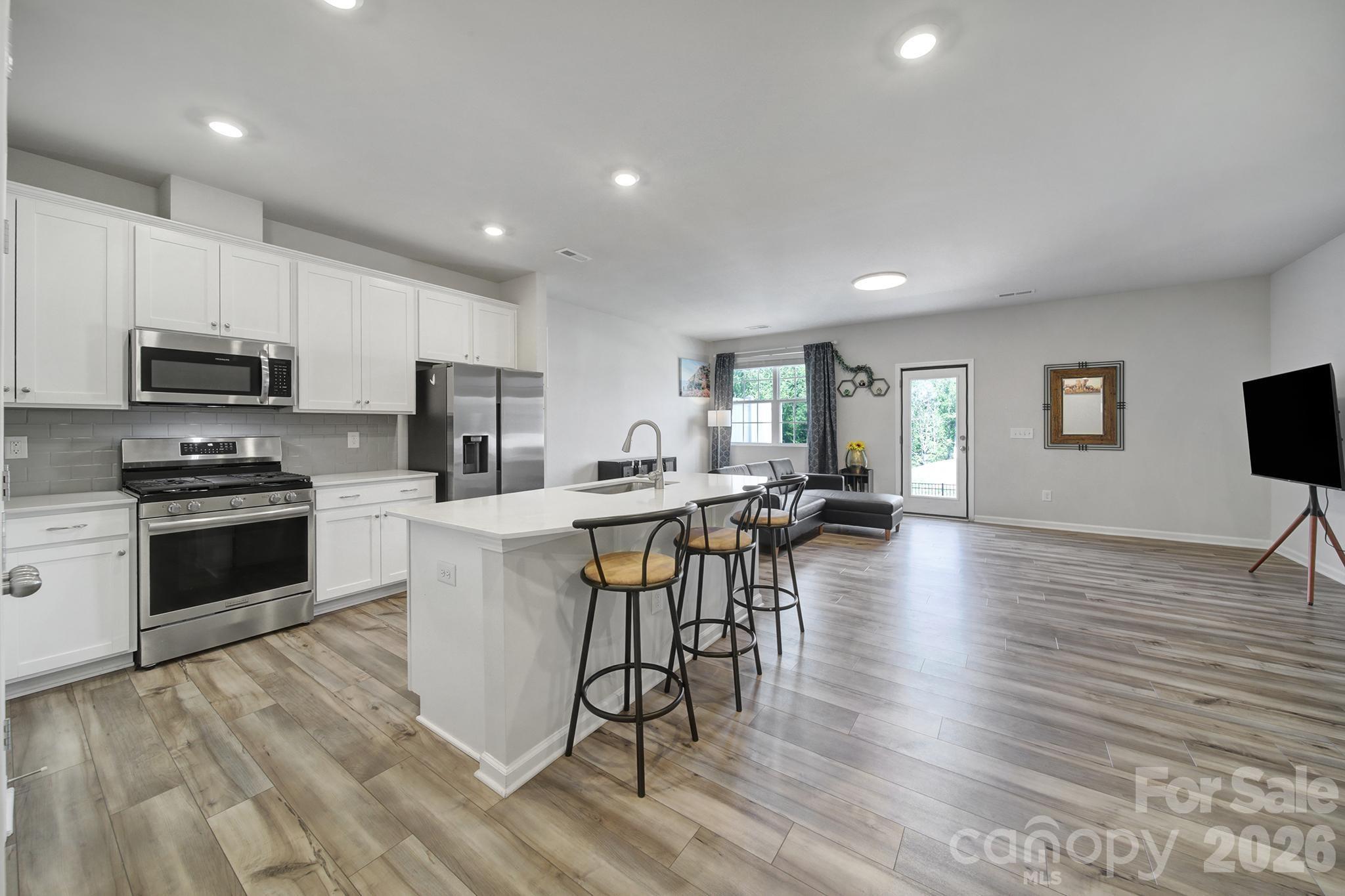 8042 Scarlet Maple Lane Fort Mill, SC 29708 - Photo 5 of 37 a kitchen with a sink a counter top space and stainless steel appliances