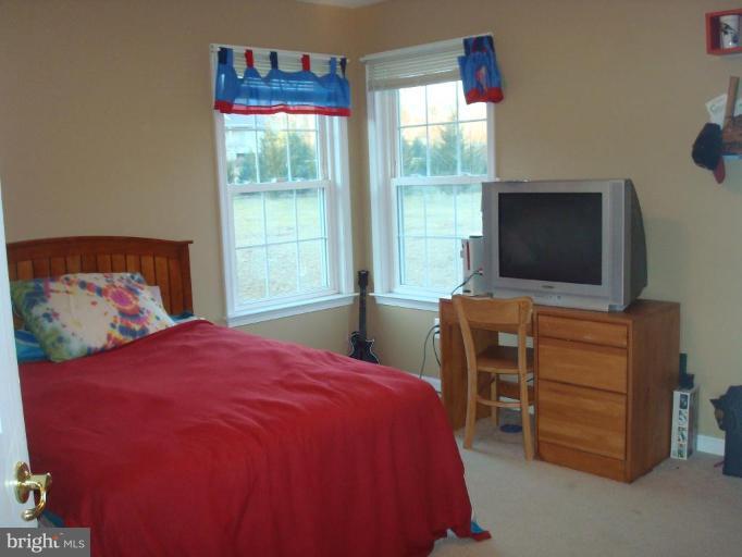 20115 Gunpowder Road Manchester, MD 21102 - Photo 28 of 29 a bedroom with a bed and a flat screen tv