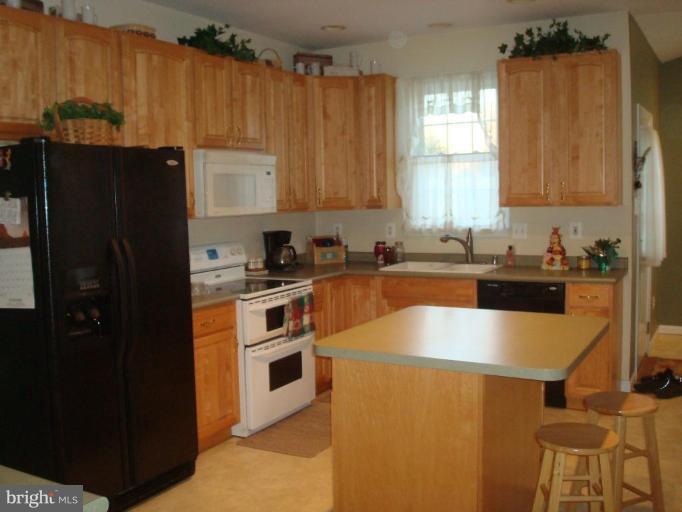 20115 Gunpowder Road Manchester, MD 21102 - Photo 5 of 29 a kitchen with stainless steel appliances granite countertop a refrigerator a sink a stove and island