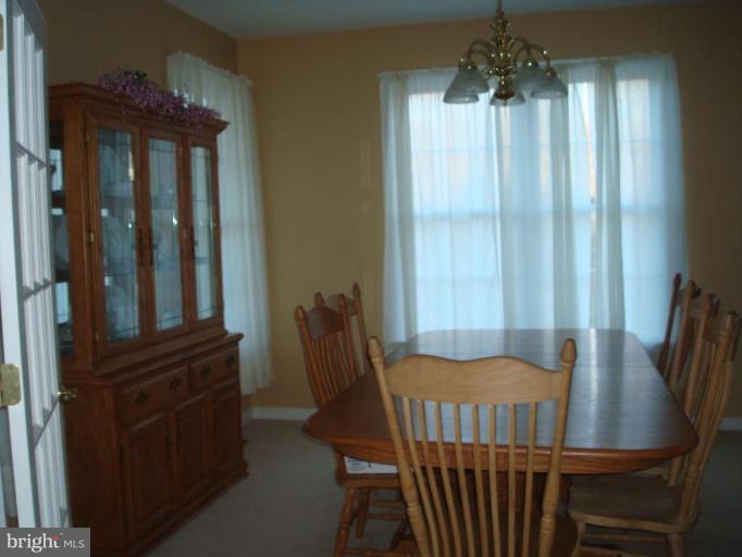 20115 Gunpowder Road Manchester, MD 21102 - Photo 8 of 29 a view of a dining room with furniture window and wooden floor