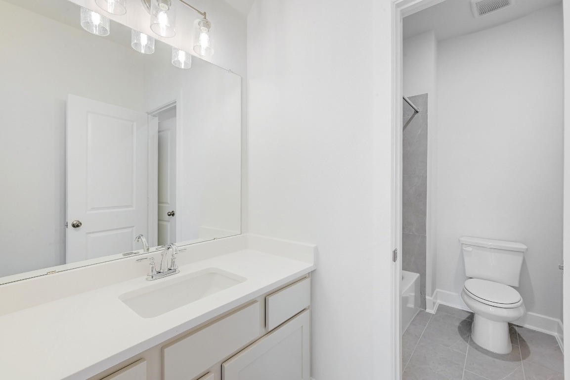 256 Star Rush Trail Georgetown, TX 78633 - Photo 16 of 23 a bathroom with a toilet a sink and mirror