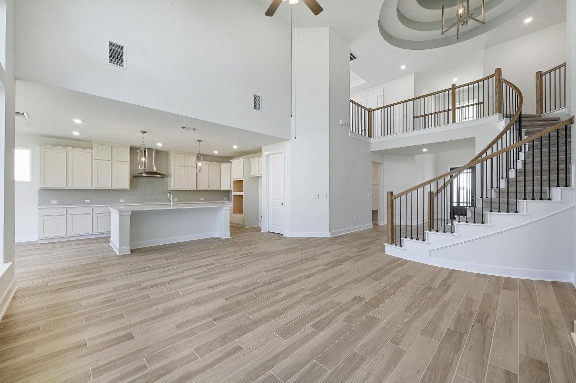 256 Star Rush Trail Georgetown, TX 78633 - Photo 4 of 23 a view of a kitchen with wooden floor and a sink