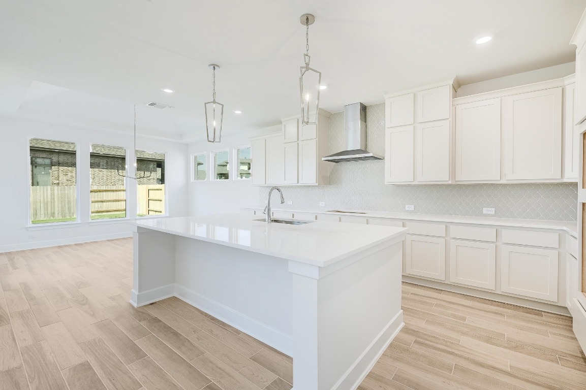 256 Star Rush Trail Georgetown, TX 78633 - Photo 5 of 23 a kitchen with kitchen island white cabinets and appliances