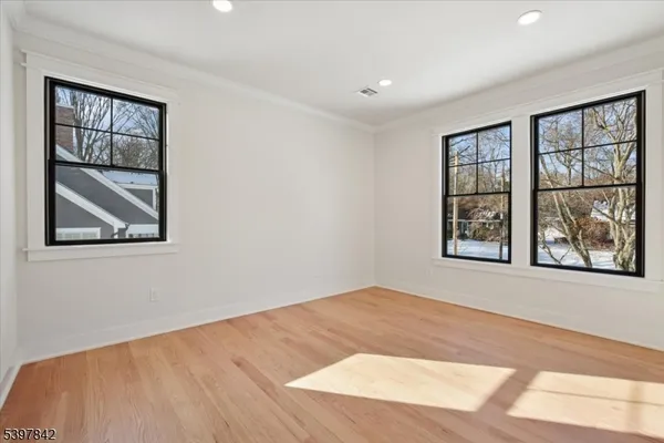 a living room with furniture a flat screen tv and a table